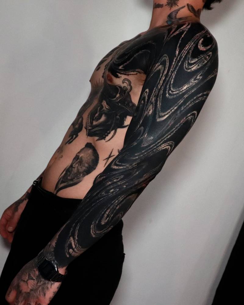 Blackwork style abstract sleeve tattoo.