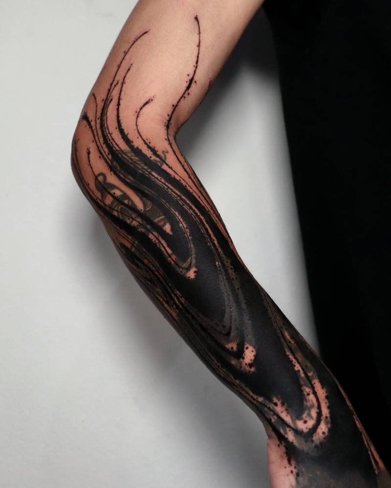 Old tattoo cover up with an abstract design.