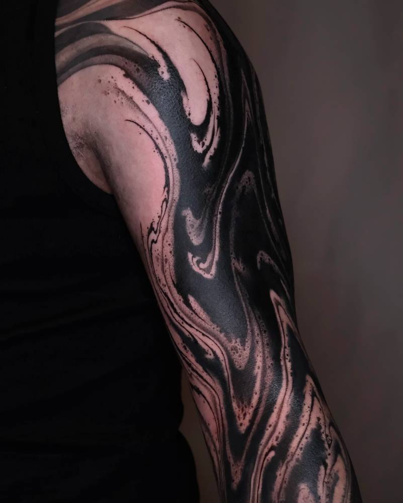Abstract half sleeve tattoo in blackwork style.