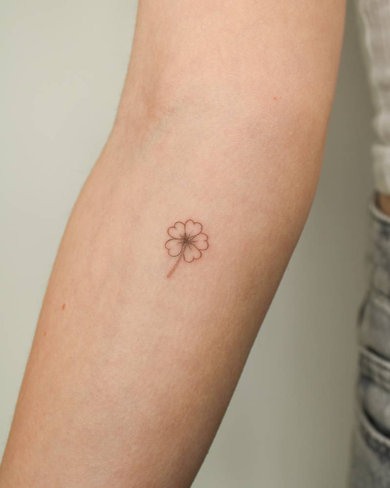 Four leaf clover tattoo in fine line style done on the inner forearm.