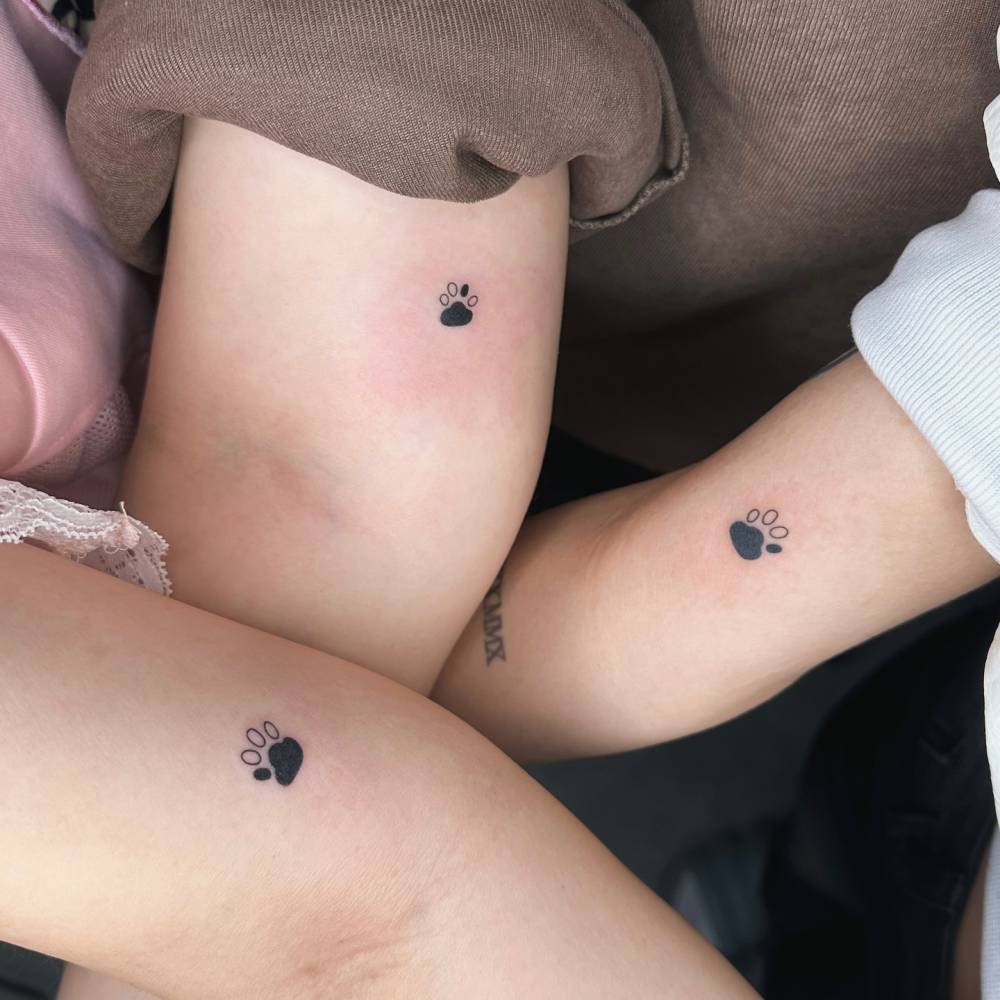 Matching minimalistic dog paw print tattoo for best friends.