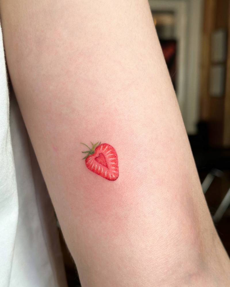 Illustrative style strawberry tattoo done on the inner arm.