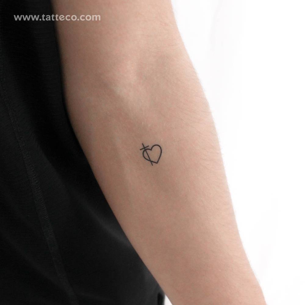 Minimalistic style cross heart temporary tattoo.