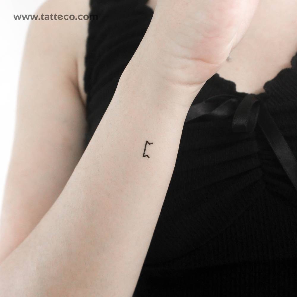 Minimalistic style peord rune temporary tattoo located on the wrist.