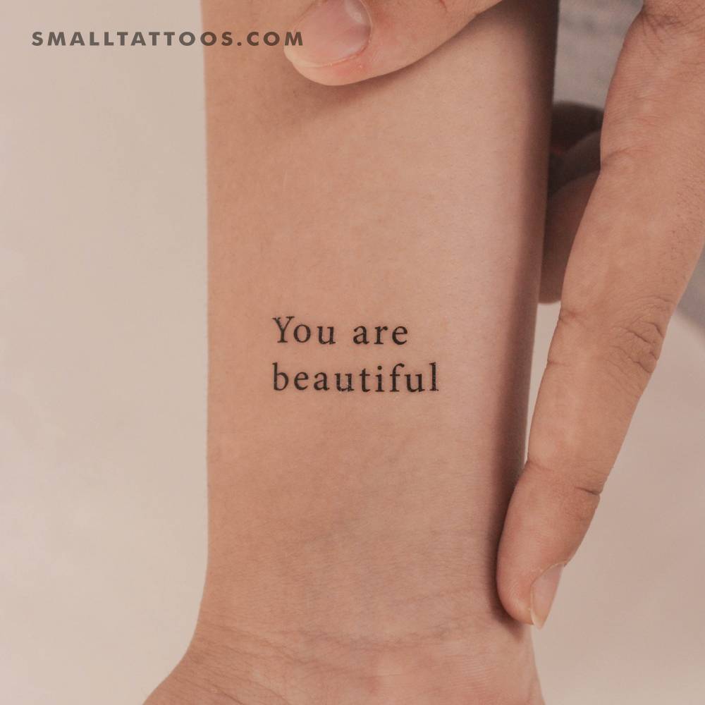 "You are beautiful" temporary lettering tattoo located on the wrist.