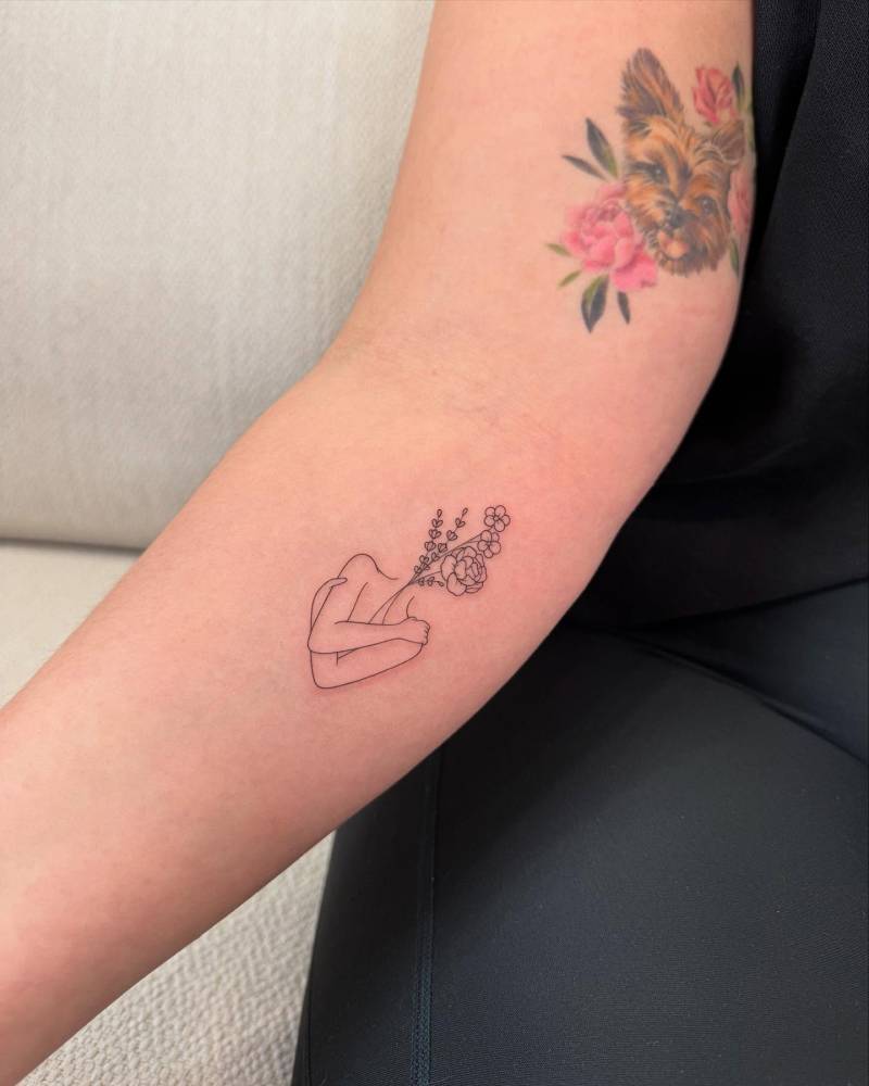 Flower head woman tattoo placed on the inner forearm.,