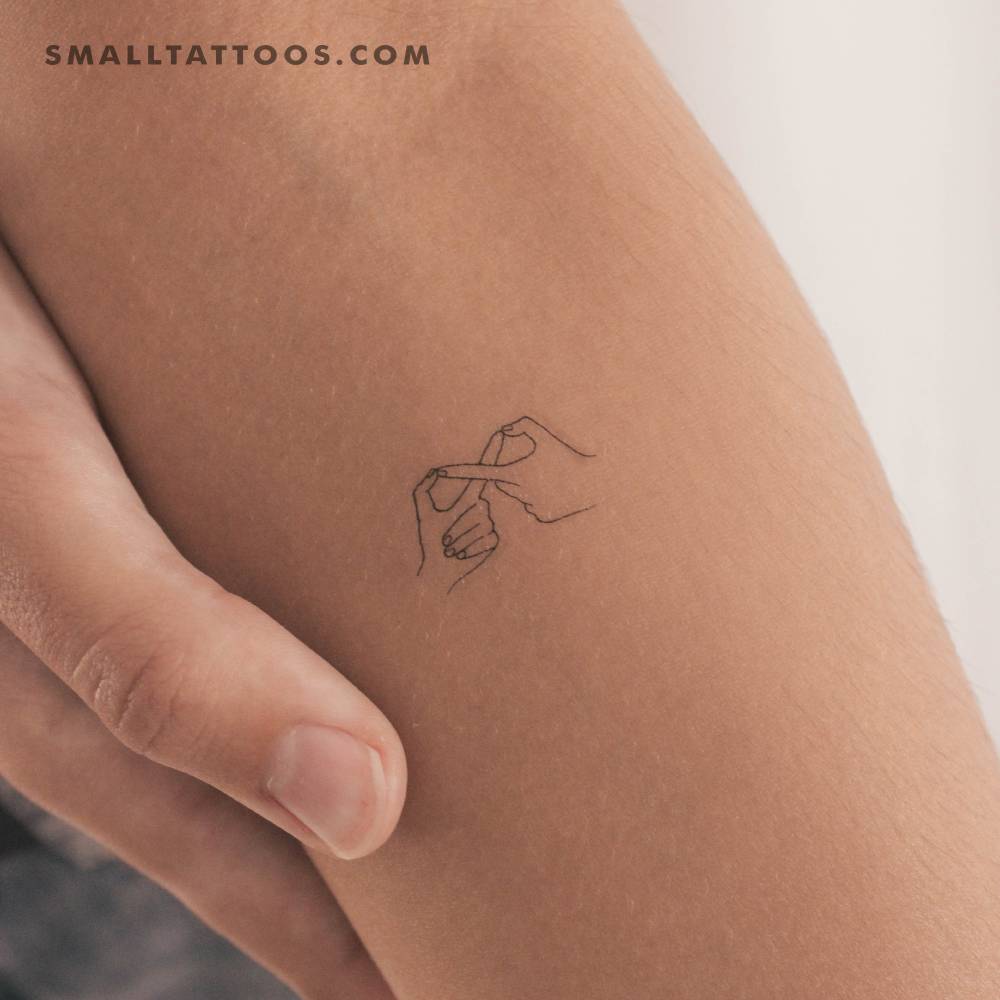 Infinity hand gesture temporary tattoo located on the inner forearm.
