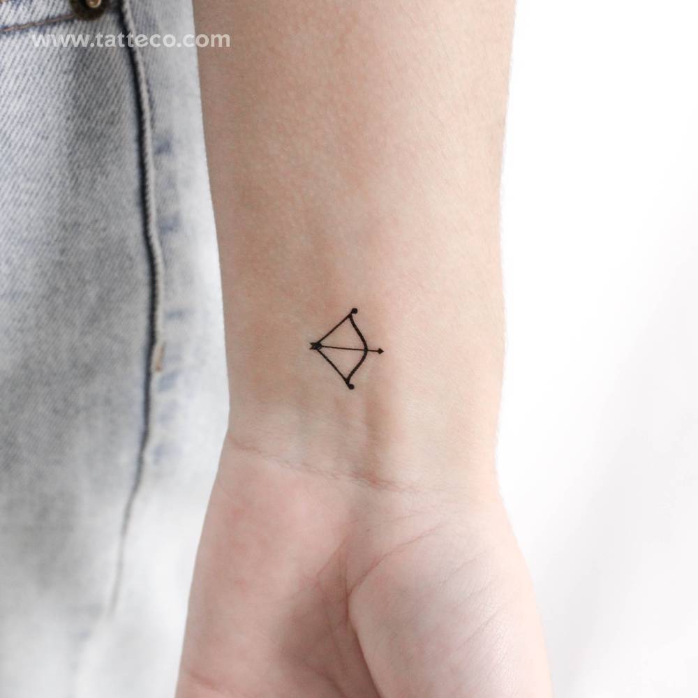 Little bow and arrow temporary tattoo located on the wrist.