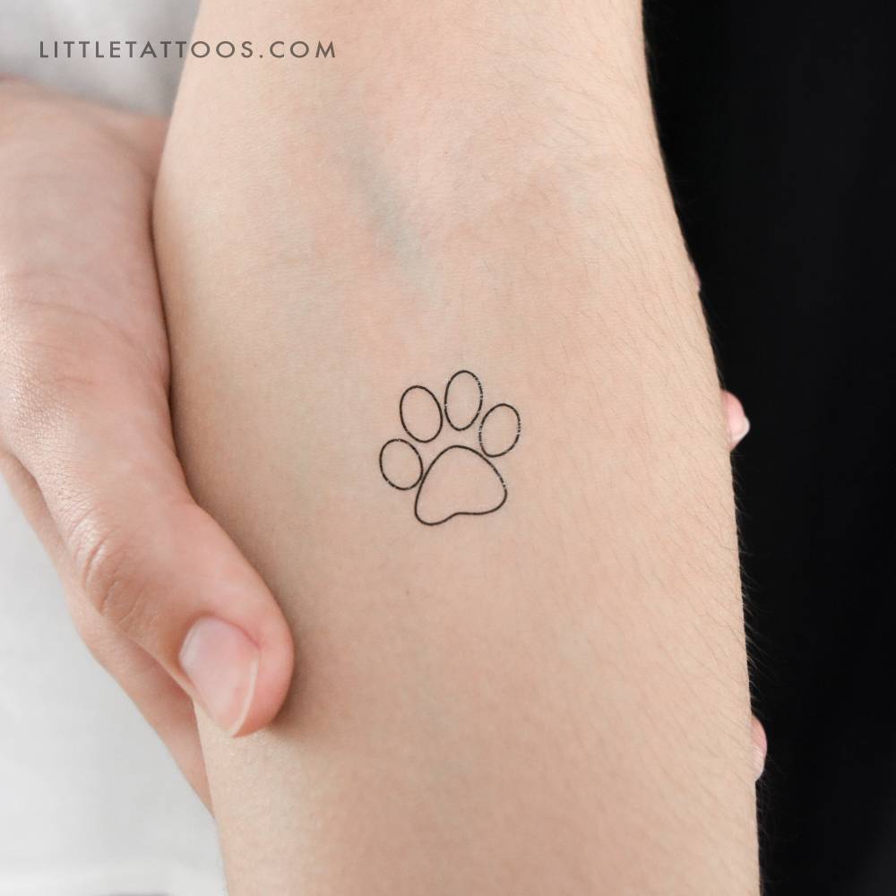 Dog paw outline temporary tattoo located on the inner forearm.