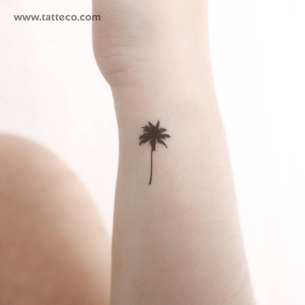 Small minimalistic palm tree temporary tattoo located on the wrist.