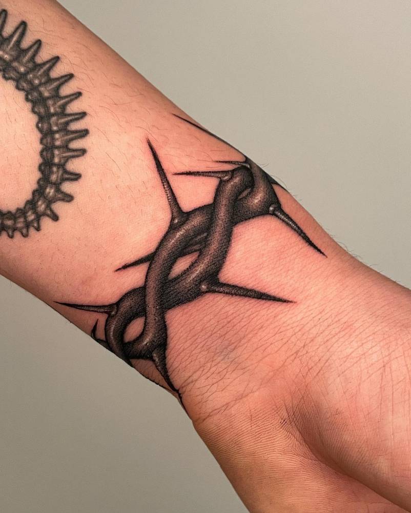 Thorn wristband tattoo in dotwork style.