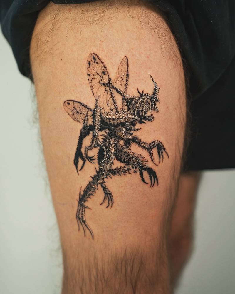 Kabuterimon from Digimon tattooed on the thigh.