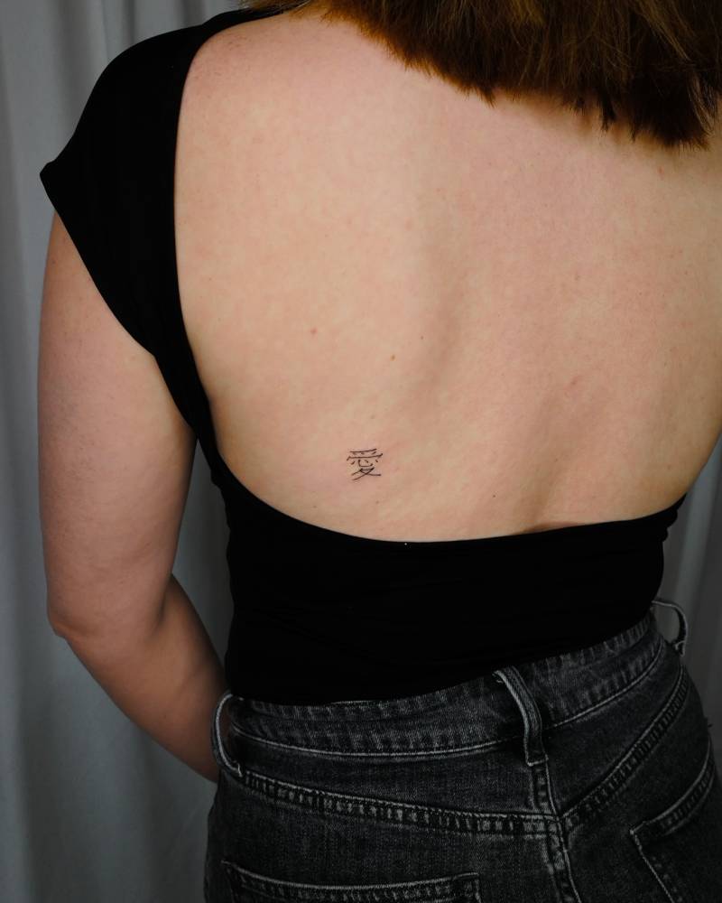 Little Chinese character tattooed on the back.