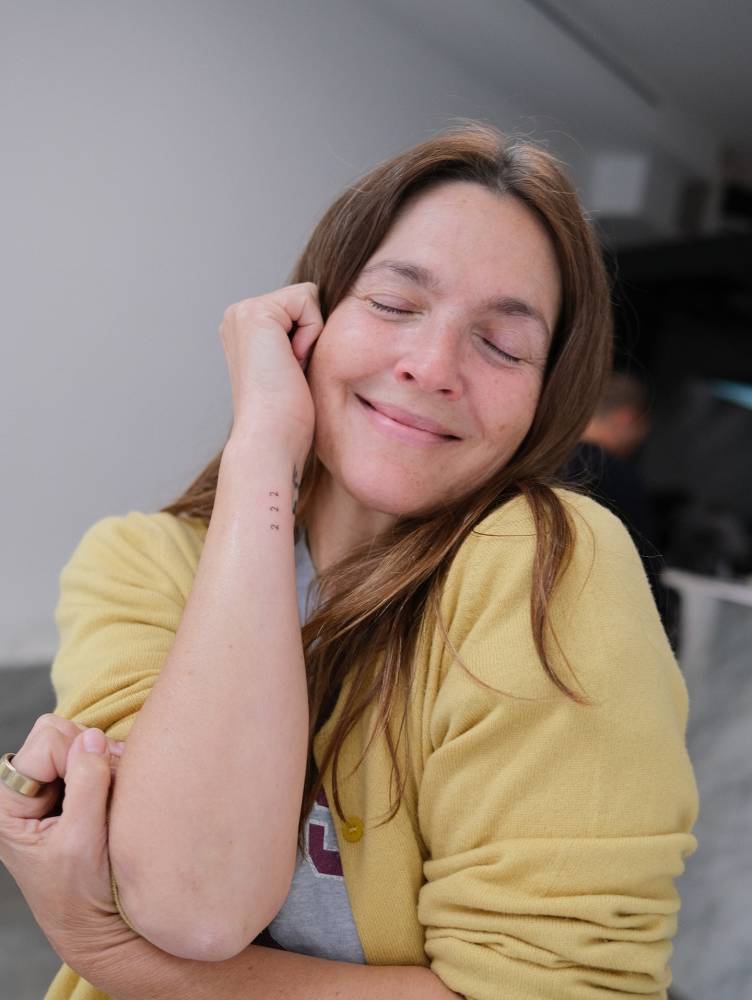 Angel number "222" tattoo located on Drew Barrymore's wrist.