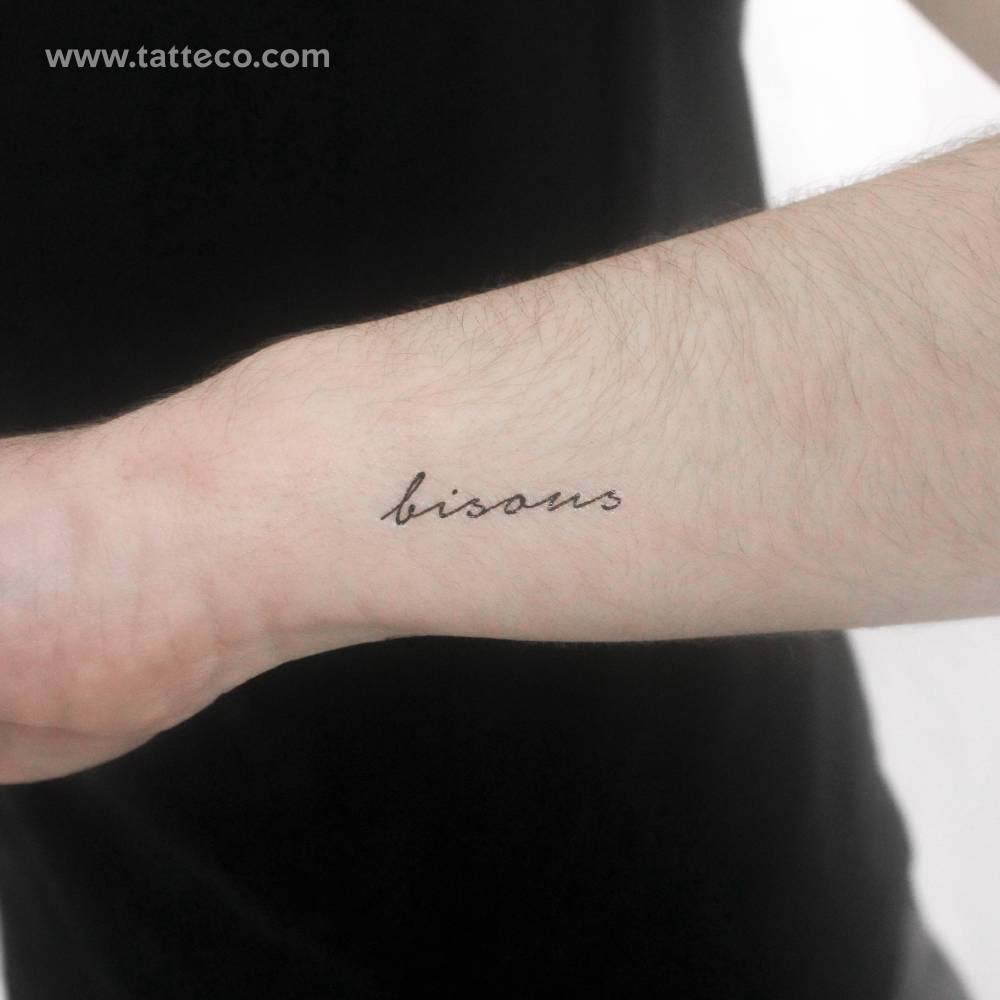 Handwritten font word "bisous" temporary tattoo located on the wrist.
