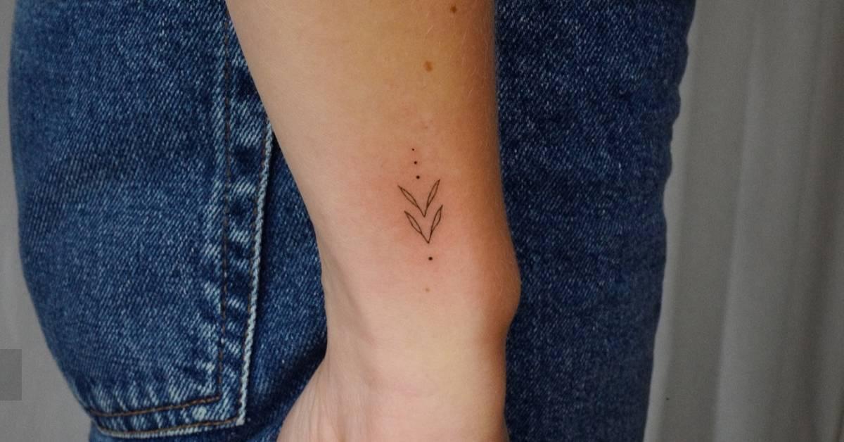 Fine line style ornamental tattoo located on the wrist.