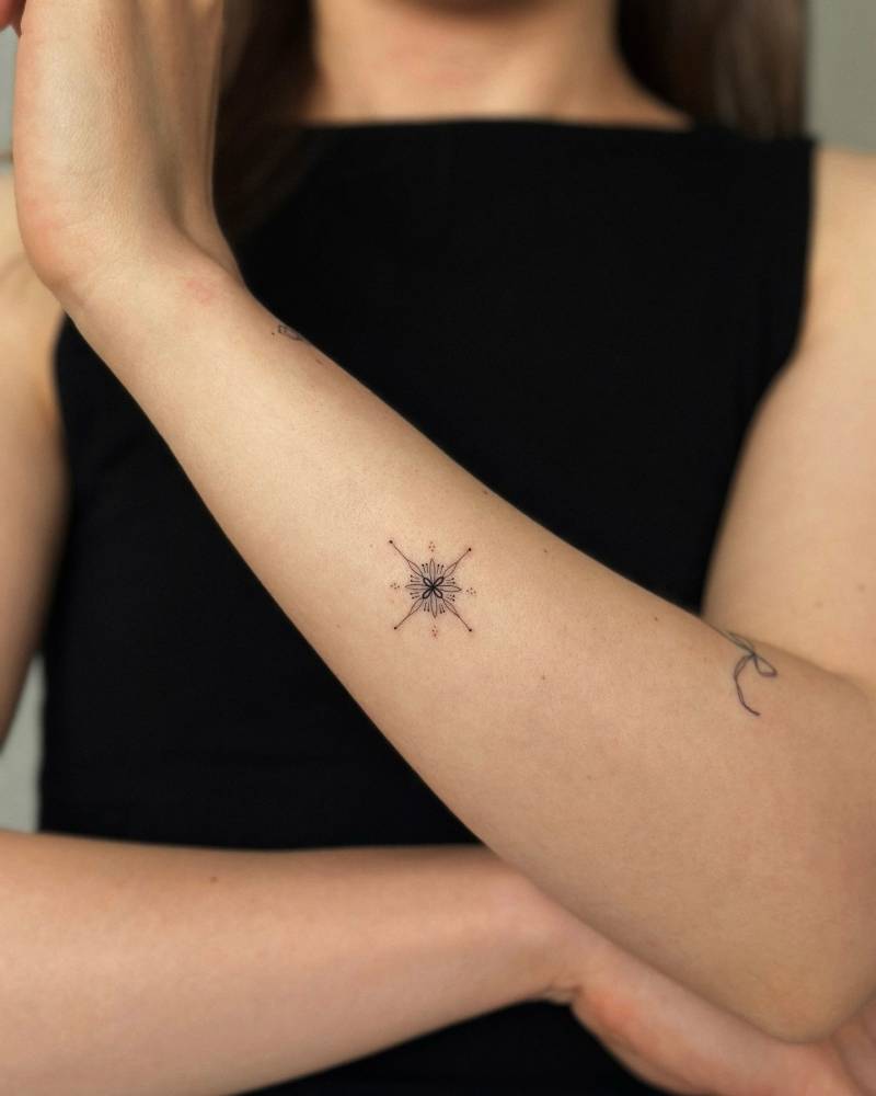 Ornamental tattoo in fine line style located on the forearm.