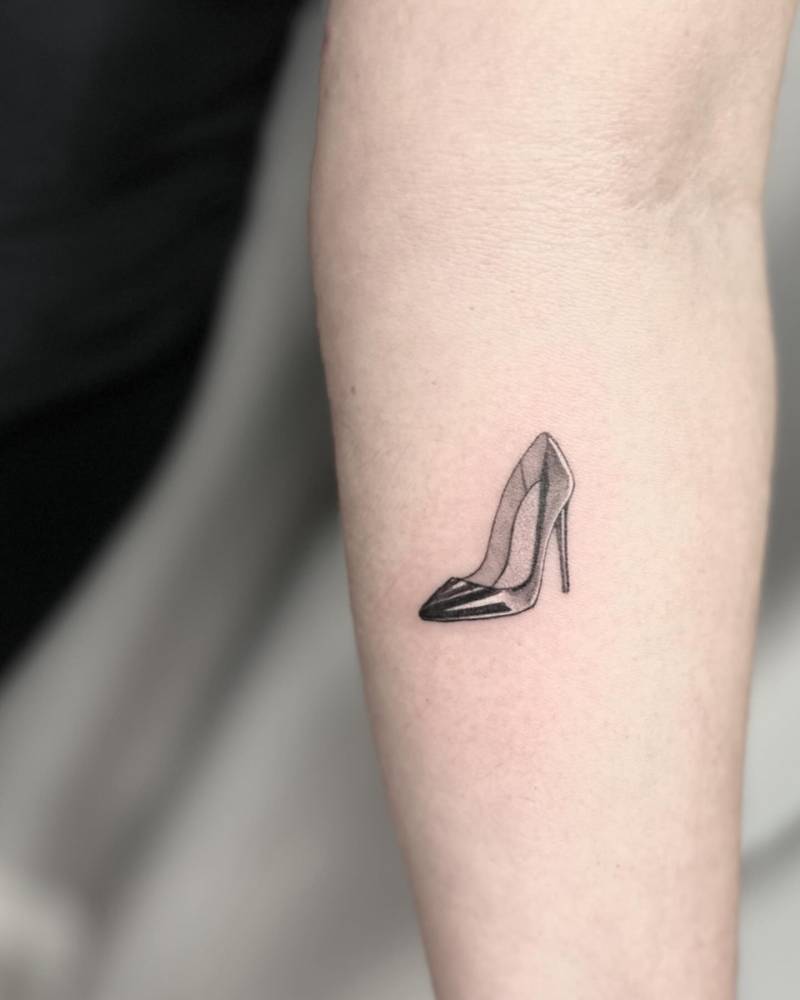 Illustrative style high heel tattoo located on the inner forearm.