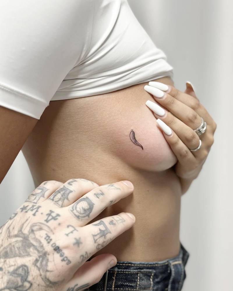 Illustrative style chili pepper tattoo located on the side boob.