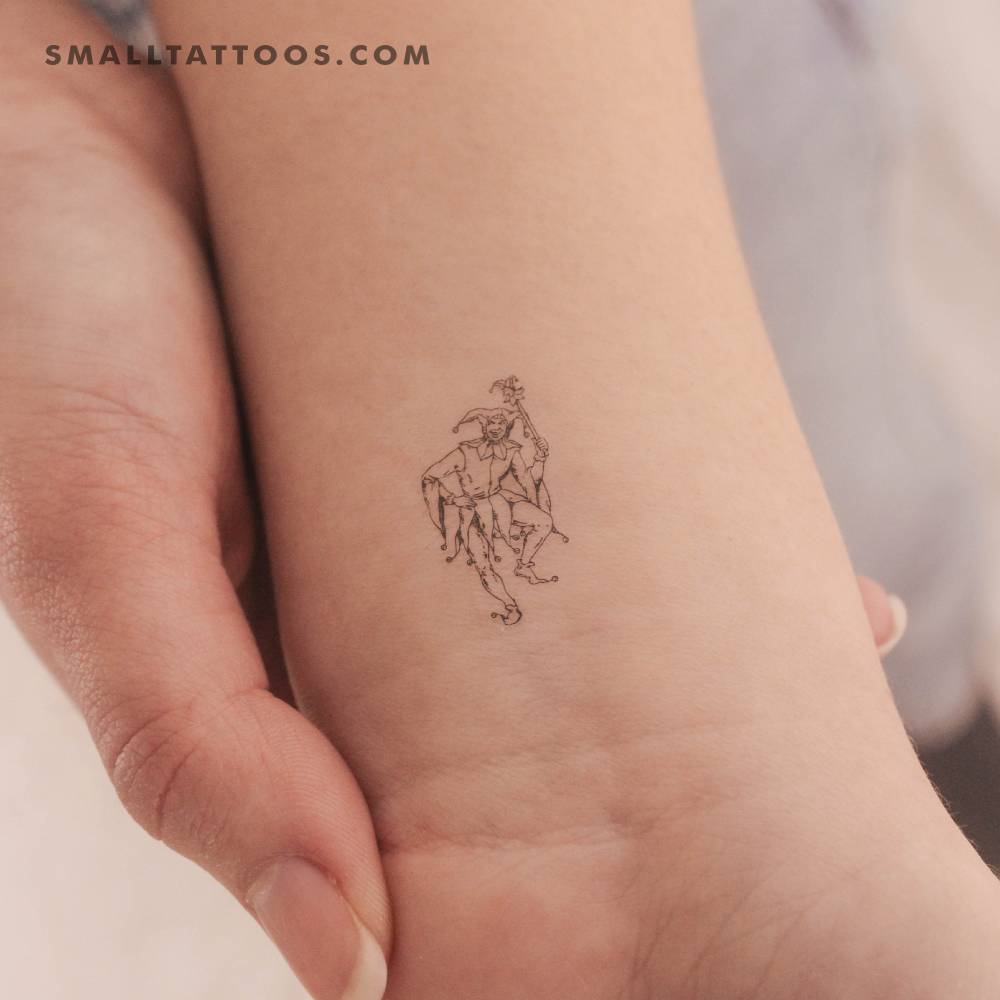 Jester temporary tattoo in fine line style located on the wrist.
