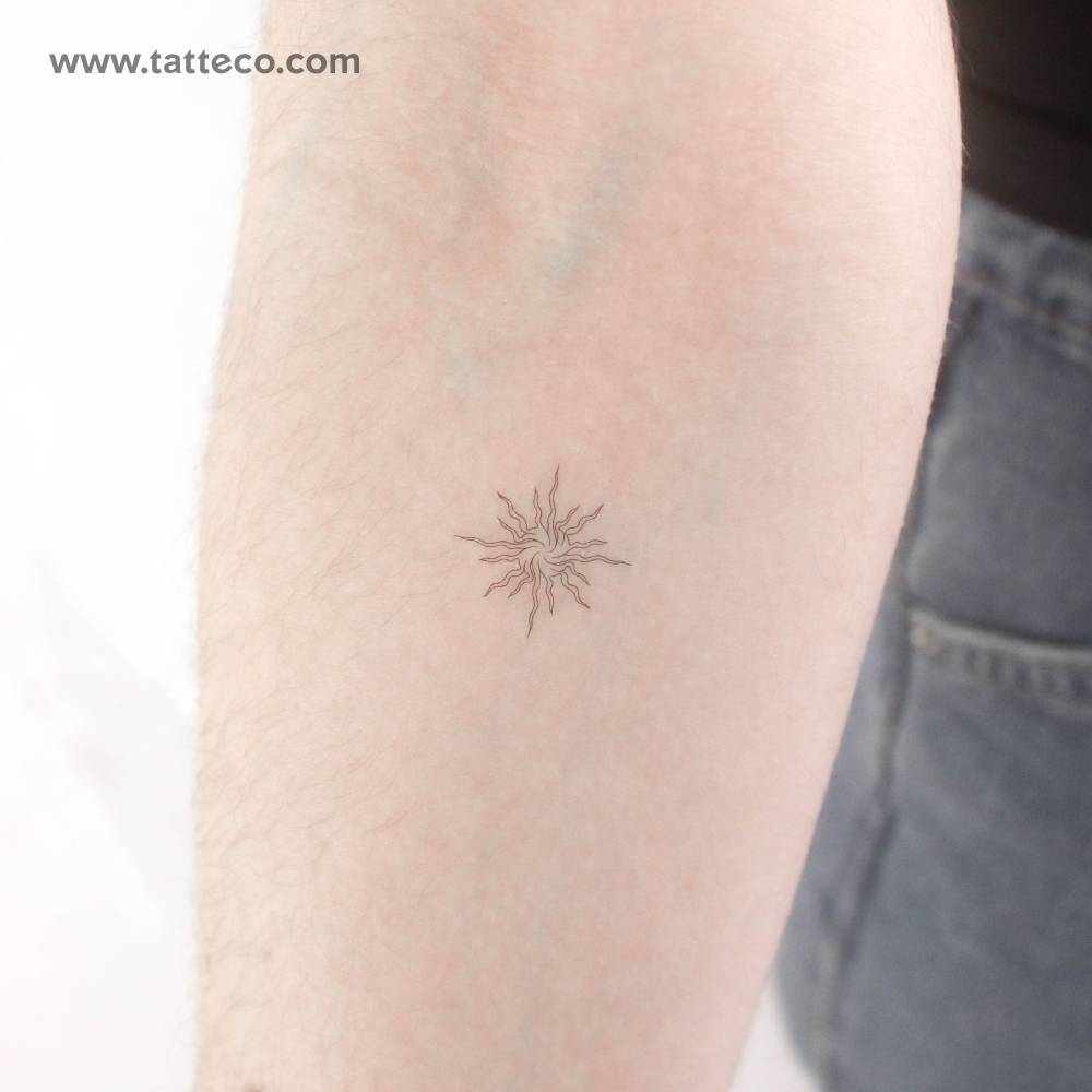 Abstract sun temporary tattoo placed on the inner forearm.