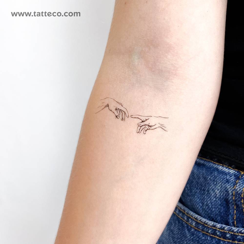Fine line style 'Creation of Adam' hands temporary tattoo.