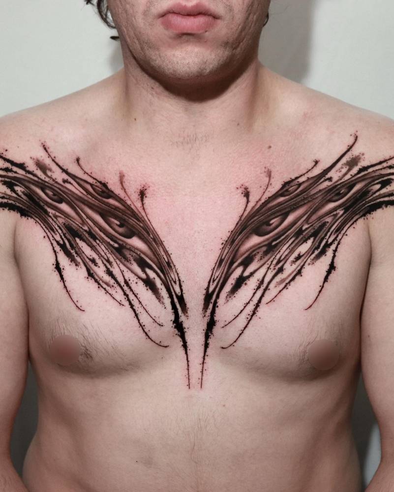Abstract eye flow tattooed on the chest, done in blackwork style.