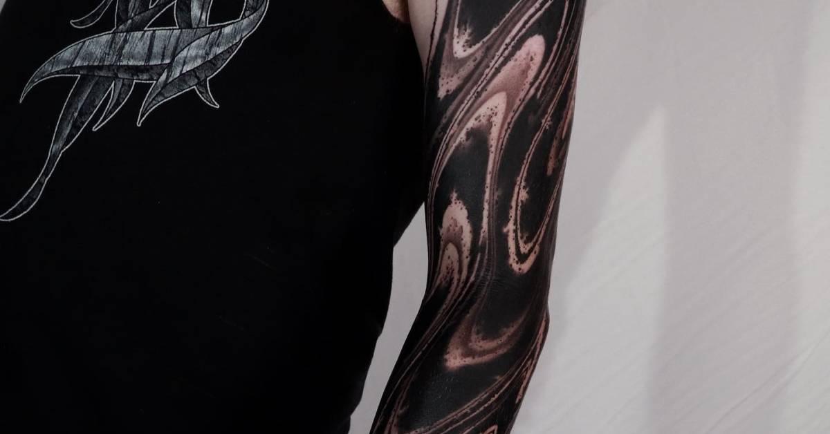 Abstract tattoo sleeve done in blackwork style.