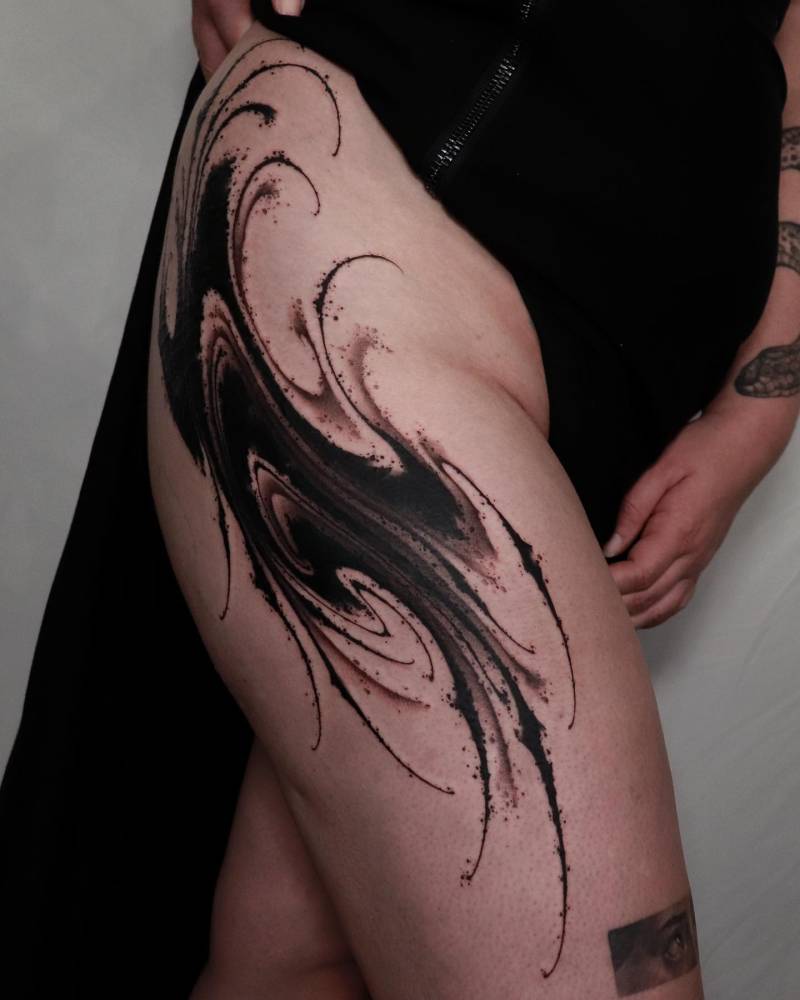 Blackwork style abstract design tattooed on the thigh.