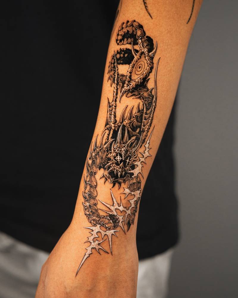 Comic style scorpion monster tattoo located on the forearm.