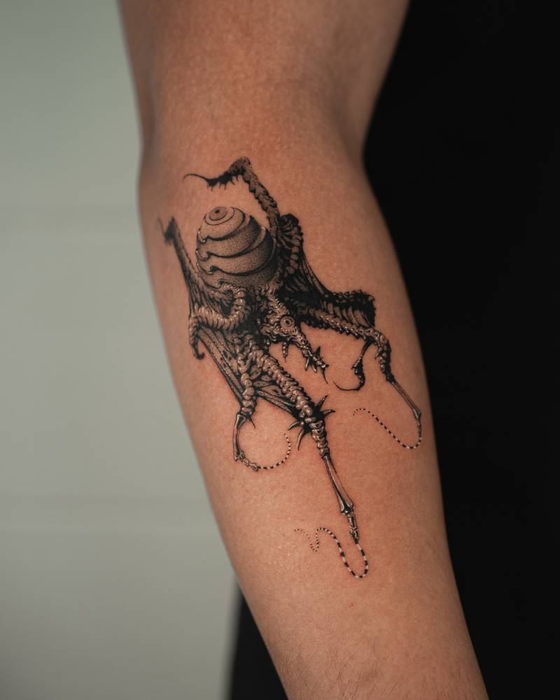 Illustrative style spider tattoo located on the forearm.