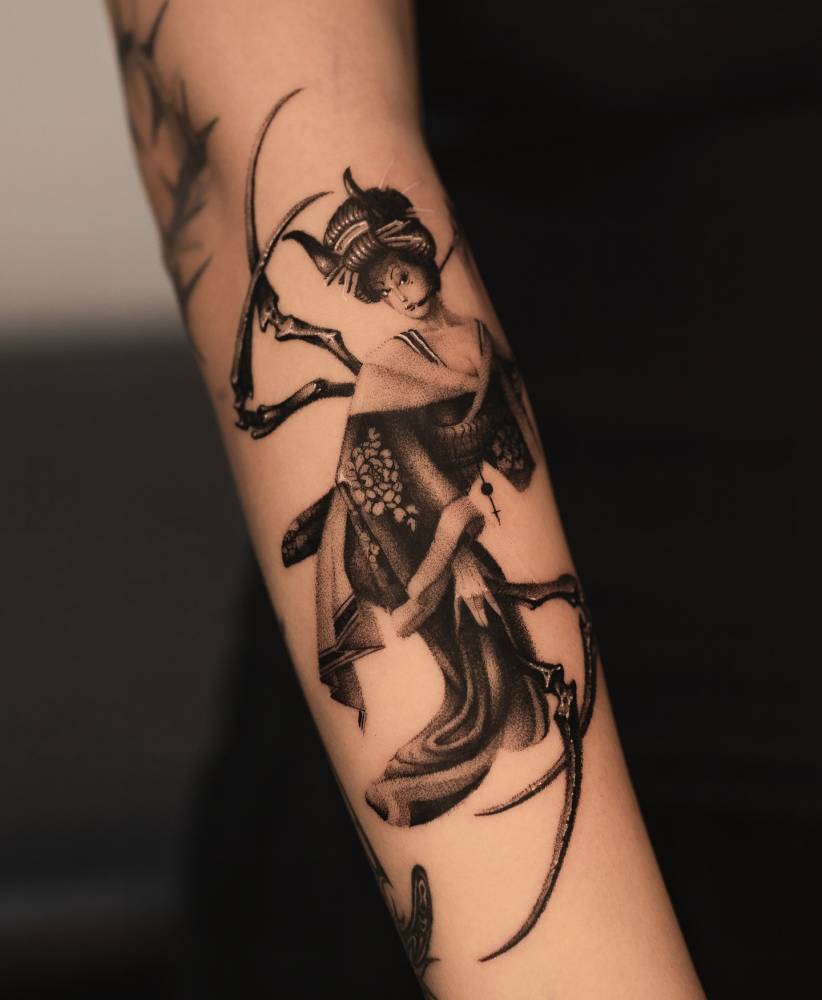 Spider geisha tattoo located on the forearm, blackwork style.