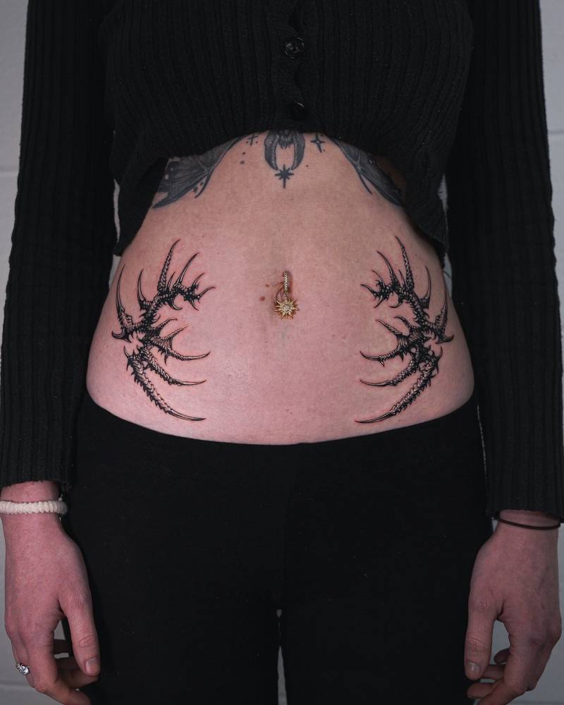 Individual matching thorns tattoo located on the waist.