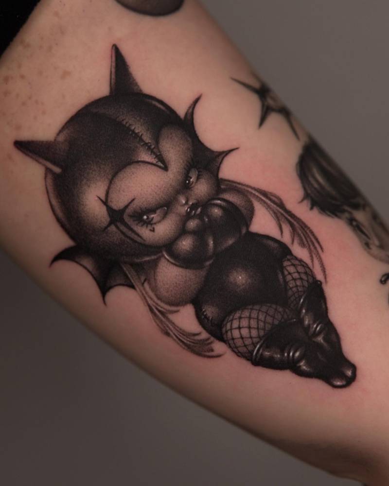 Kewpie Catwoman tattoo located on the inner arm.