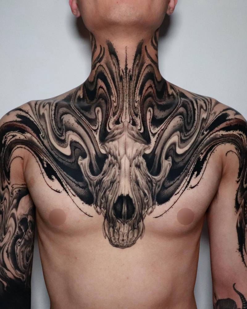 Abstract wolf skull tattoo located on the chest.