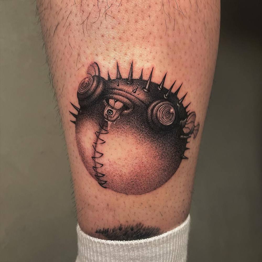 Cyber pufferfish tattoo located on the shin, done in dotwork style.