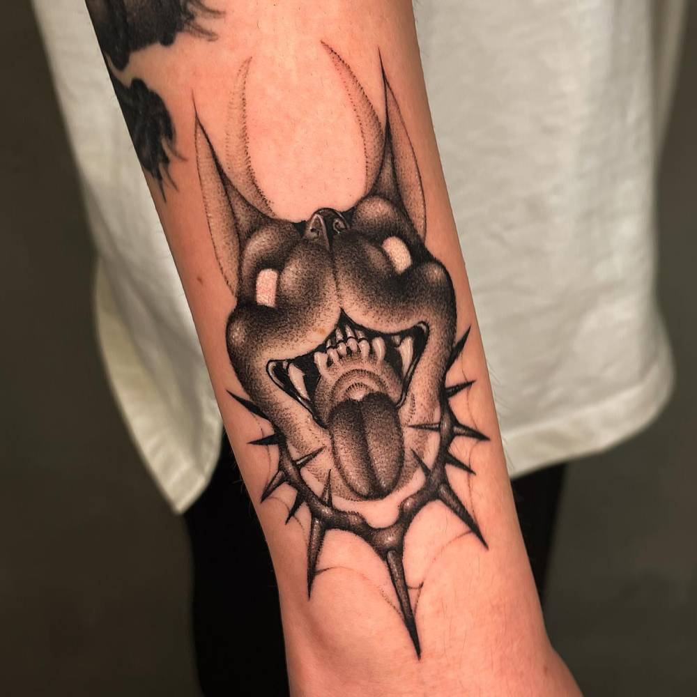 Dotwork style Pinscher portrait tattoo located on the wrist.