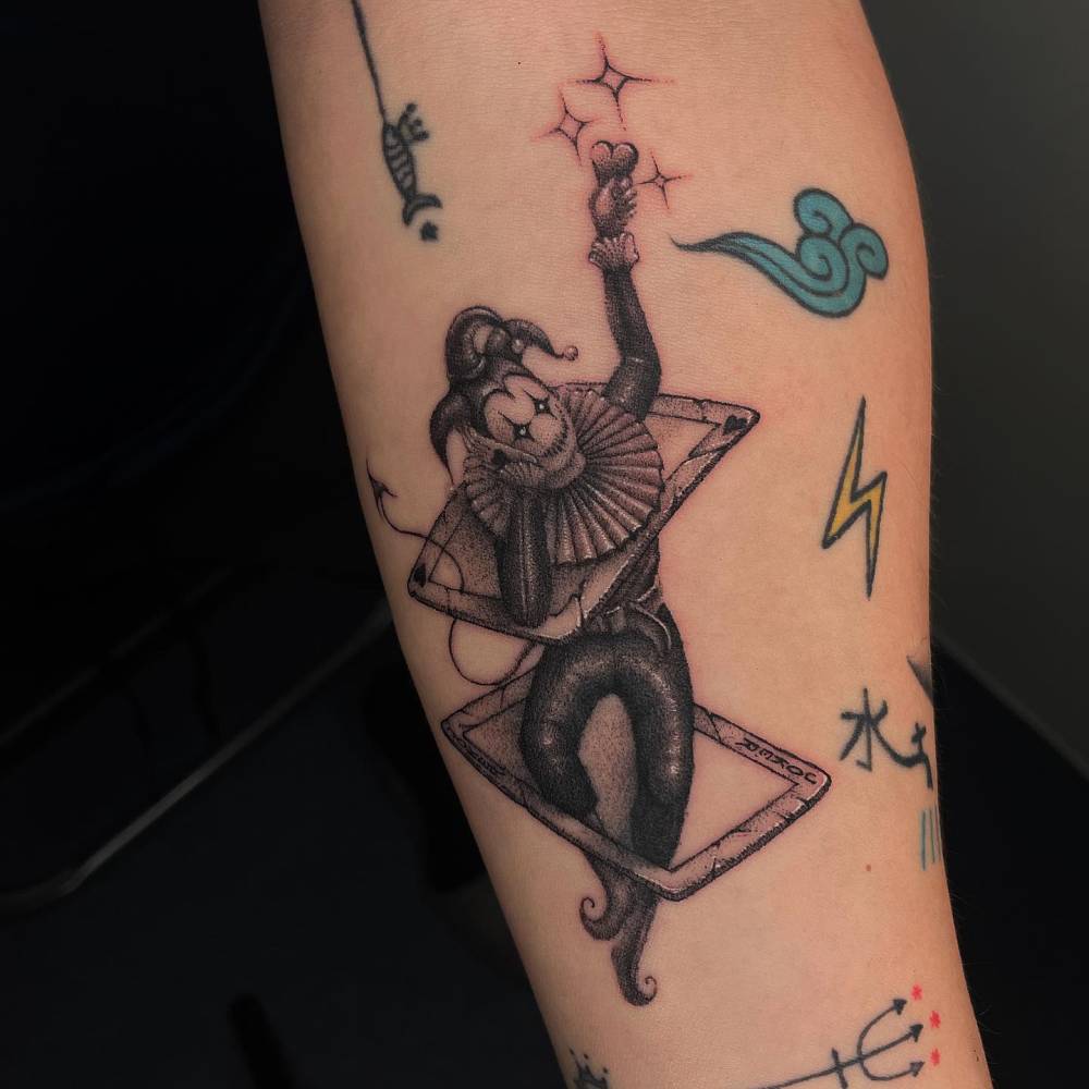 Illustrative style Joker tattoo done on the inner forearm.