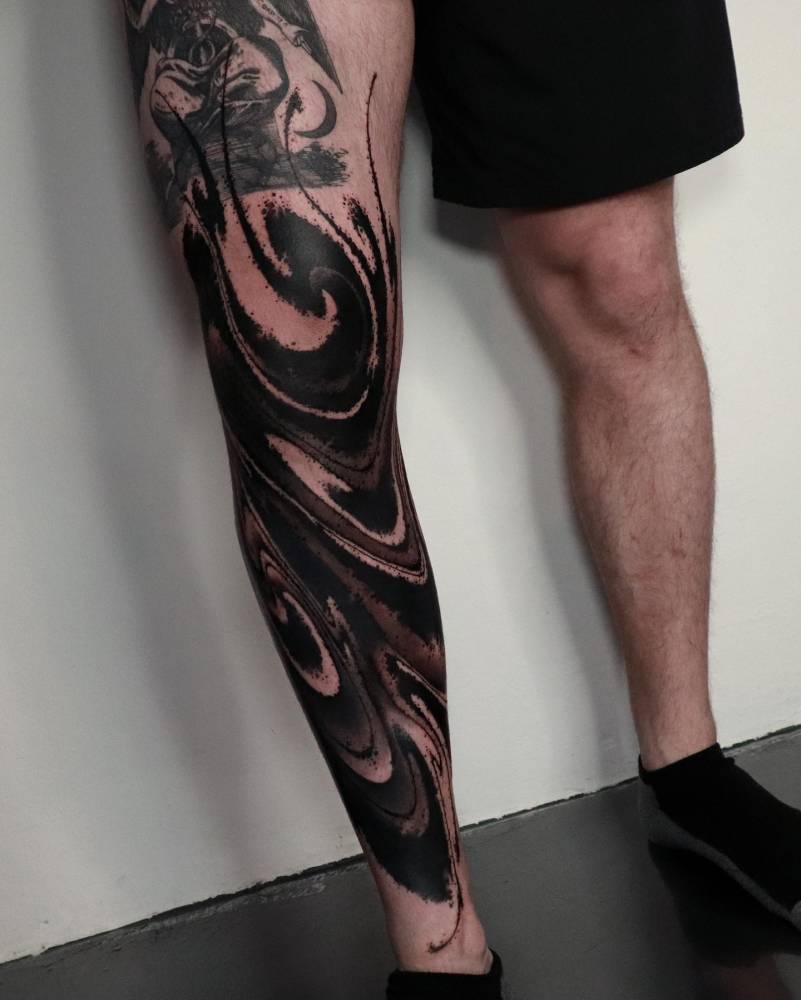 Blackwork style abstract design tattooed on the leg.