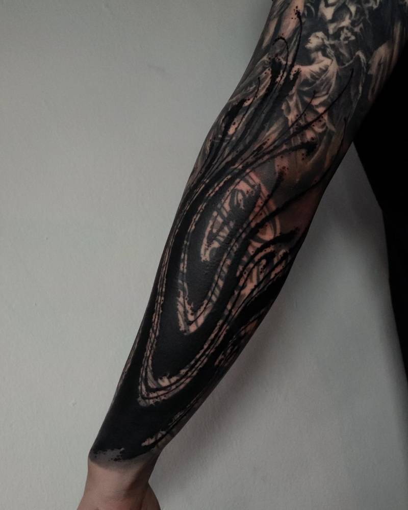 Abstract cover up tattoo in blackwork style, located on the forearm.