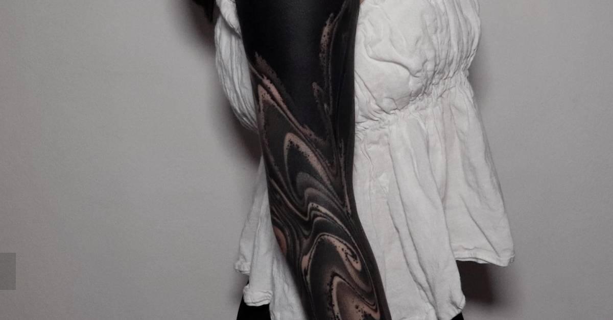 Abstract sleeve tattoo in blackwork style.