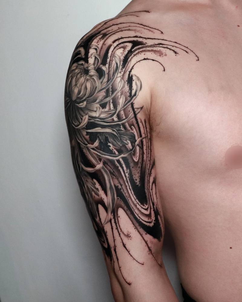 Abstract style chrysanthemums tattoo located on the upper arm.