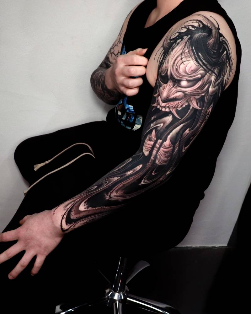 Hannya tattoo sleeve done in black and grey style.