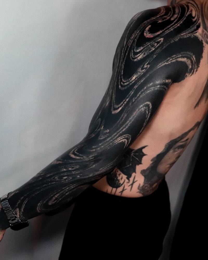 Blackwork style abstract sleeve cover up tattoo.