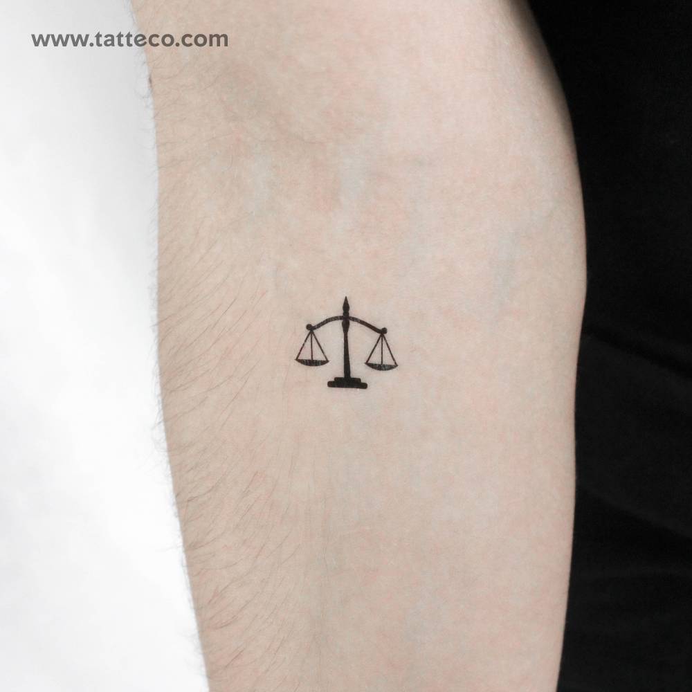 Minimalistic style scale temporary tattoo placed on the inner forearm.