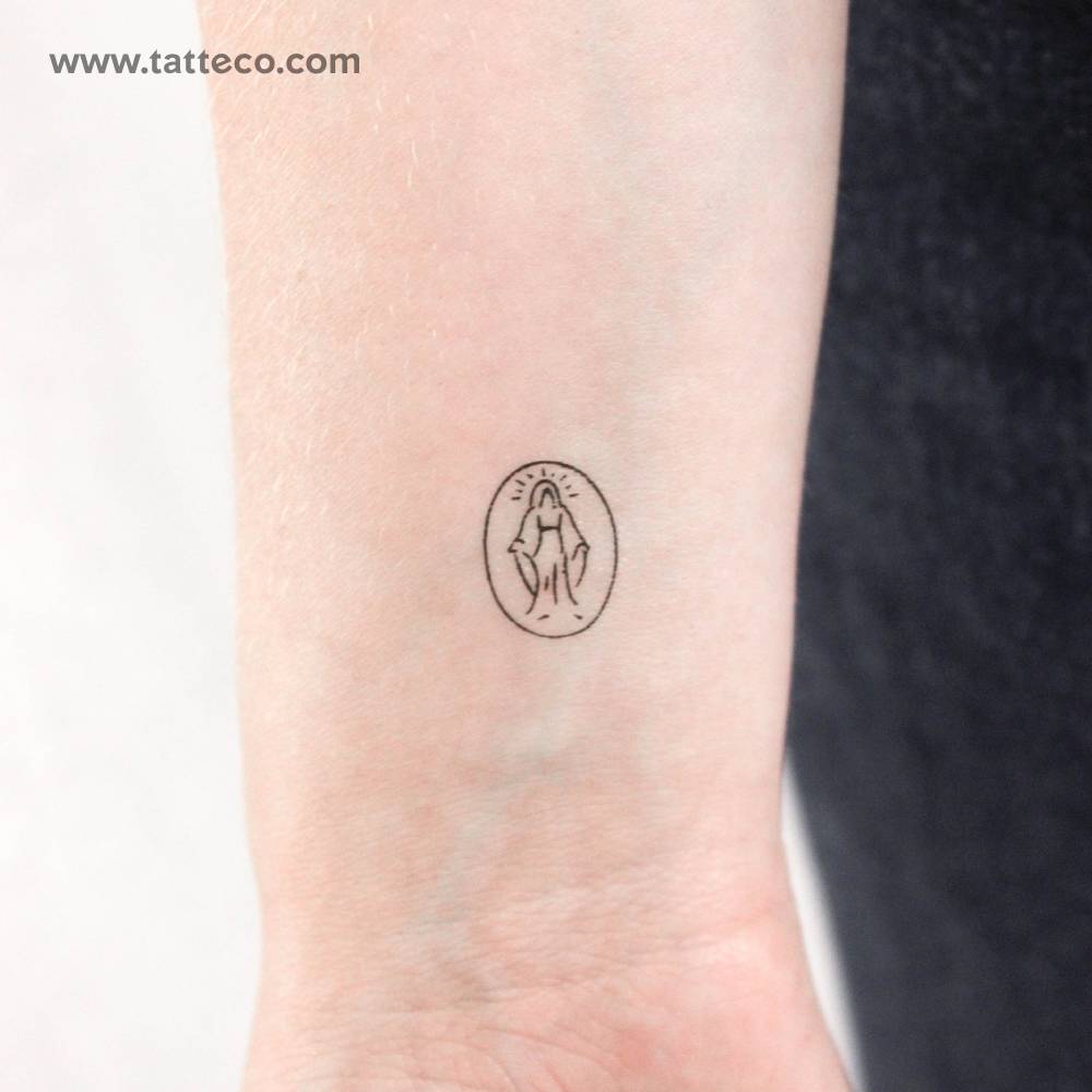 Minimalistic style tiny Virgin Mary temporary tattoo located on the wrist.