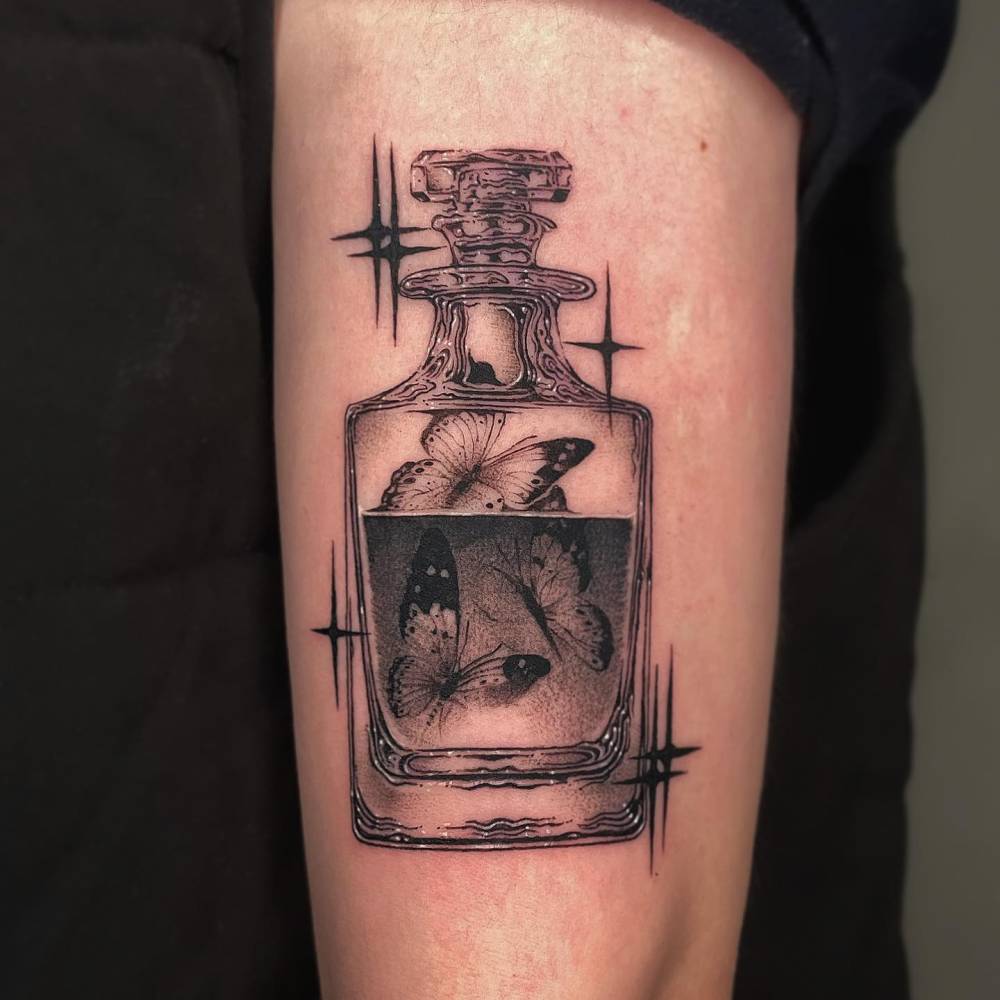 Butterflies in a bottle tattoo located on the upper arm, illustrative style.