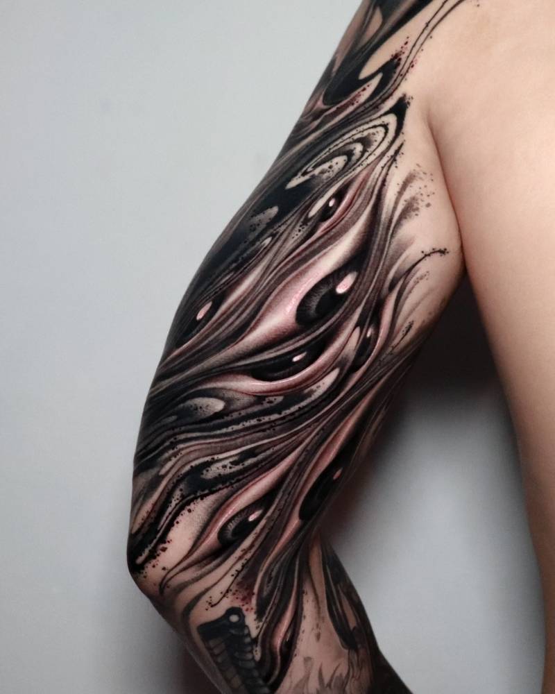 Abstract eye flow tattoo located on the inner arm.