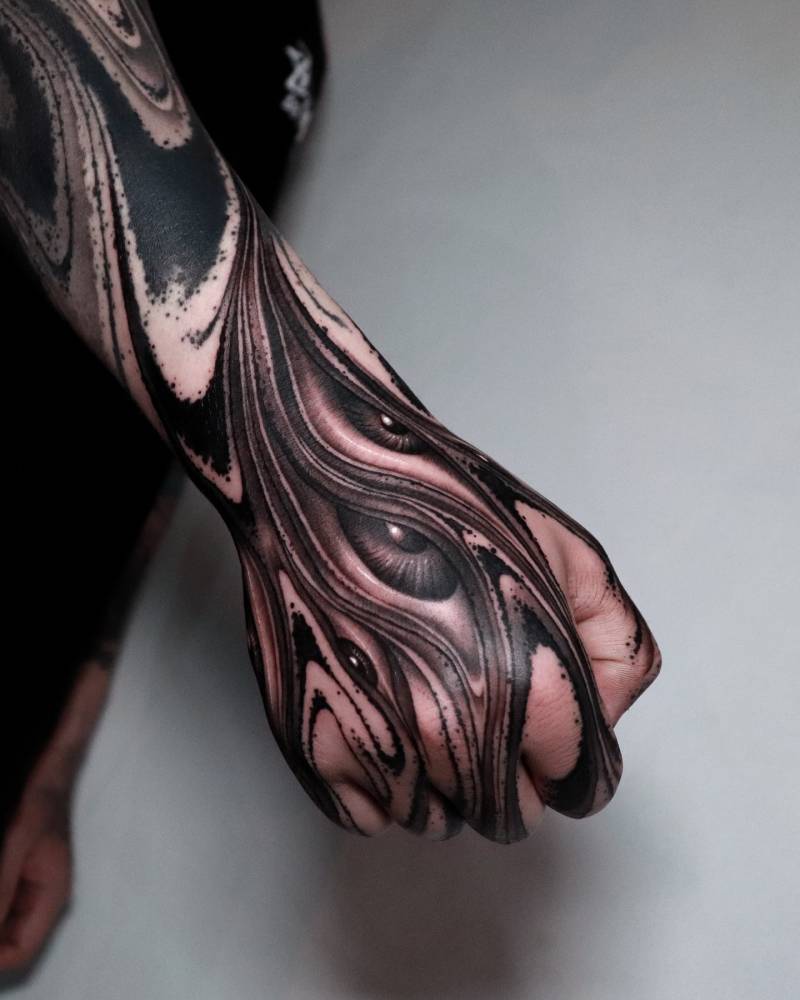 Eye flow tattoo in abstract style located on the hand.