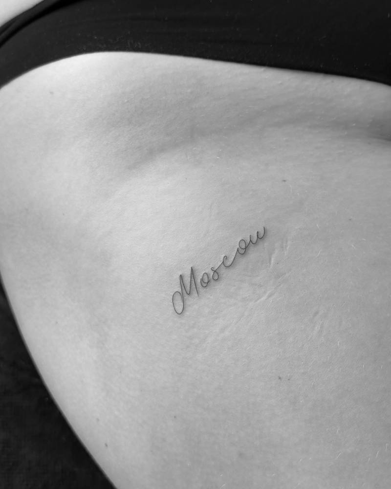"Moscow" handwritten lettering tattoo placed on the thigh.